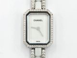 a close up of a wrist watch with diamonds on a white surface