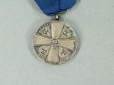 a silver medal with a blue ribbon around it