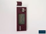 a picture of a red electronic device on a white wall