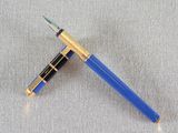 a close up of a blue pen with a gold trim