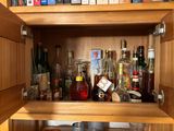 a wooden cabinet with a lot of bottles on it