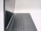a laptop that is open on a white surface