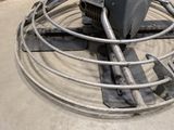 a large metal fan sitting on top of a cement floor