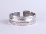 a close up of a silver ring on a white surface