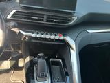 a car dashboard with a laptop on it and a cell phone in the center
