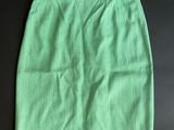 a green skirt on a black surface