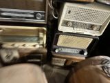 an old radio sitting on top of a table next to a bed