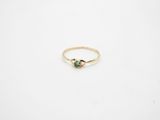 a gold ring with a green tourmaline stone