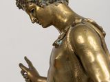 bronze statue of a boy with a bird on his shoulder