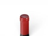 bottle of red wine on a white background with a red cap