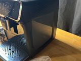 a black coffee machine sitting on a wooden table