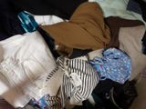 a pile of clothes that is sitting on the floor