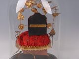 a glass clochet with a hat on top of it