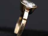 a close up of a gold ring with a diamond on it