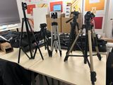 many cameras that are sitting on a table in a room