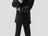 a figurine of a man in a suit and tie