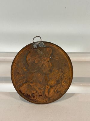 an old coin sitting on a shelf in a room