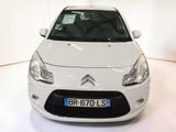 a white car that is parked in a white room