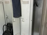 two lockers and a chair in a small room
