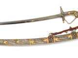 pair of antique swords with gold and silver decoration on a white background