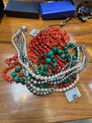 a table with a bunch of necklaces and bracelets on it