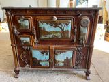 a wooden cabinet that has a painting on it
