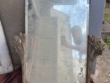 a mirror that is sitting on the ground next to a building