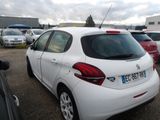 a white car parked in a parking lot with other cars