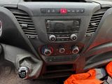 a man sitting in the driver ' s seat of a car
