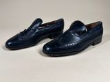 men ' s navy leather loafers with tassels on each side