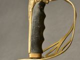 an image of a gold colored sword with a lion head on it