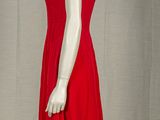 a red dress on a mannequin display on a stand
