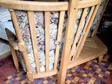 a wooden rocking chair with a floral seat cover