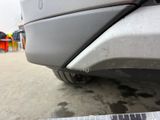 a close up of a car ' s bumper with a tape on it