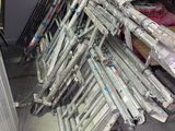 a lot of baseball bats stacked up in a room
