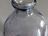a clear glass vase sitting on a white surface