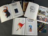 several books on a table with drawings and pictures of people