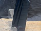 a cell phone that is sitting on a wooden table