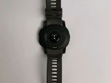 a close up of a watch on a white surface with a plastic strap