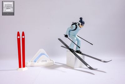 a toy skier that is jumping over a ramp