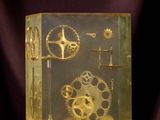 a glass box with a clock inside of it on a table