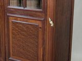 a large wooden cabinet with a glass door on it