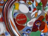 a close up of a glass vase with a red label on it