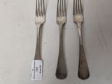 three forks and a knife on a table with a price tag