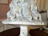 a statue of a dog sitting on top of a table