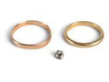 two rings and a screw on a white surface