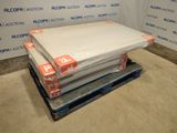 a stack of mattresses sitting on a pallet in a room