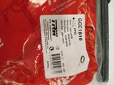 a red bag with a label on it sitting on a table