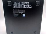 the back of a black laptop with a battery on top of it
