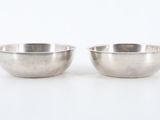pair of silver plated bowls on a white background